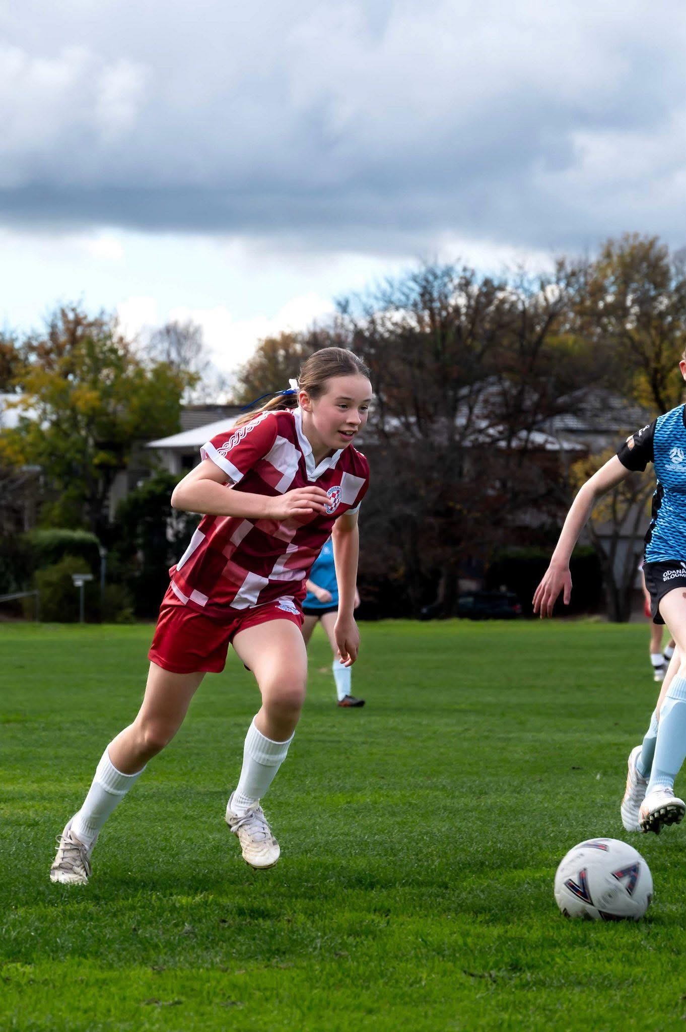 Junior player driving forward with the ball